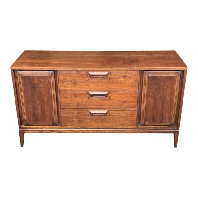 Timeless Mid-Century Modern design meets exceptional craftsmanship in this beautifully restored walnut credenza....