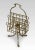 Brass music / magazine rack with scrolled and railed divisions, on three out splayed supports termanating in paw feet....