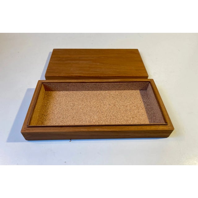 A solid teak box with one large compartment lined with cork. Made anonymously in Denmark during the 1960s in a style...