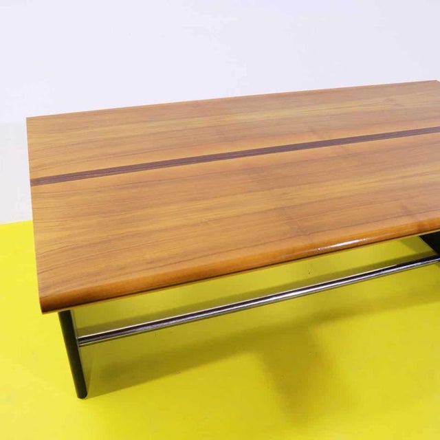 Vintage desk featuring a wooden top and black lacquered sides.
