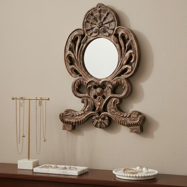 Dimensions: 16" W x 1" D x 24" H This intricately hand carved vintage mirror wears a distressed finish. Beautiful as a...