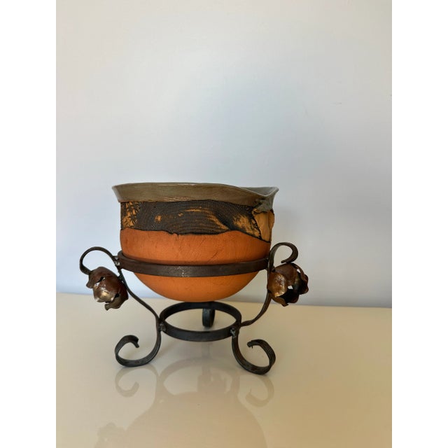 This piece is stunning and I really don't know much about it. Looks like a Raku piece. The stand is almost brutalist. It...