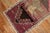 A mid-20th century authentic Turkish rug depicting a lion on a striated purple ground. Measures: 1'10" x 3'2”.
