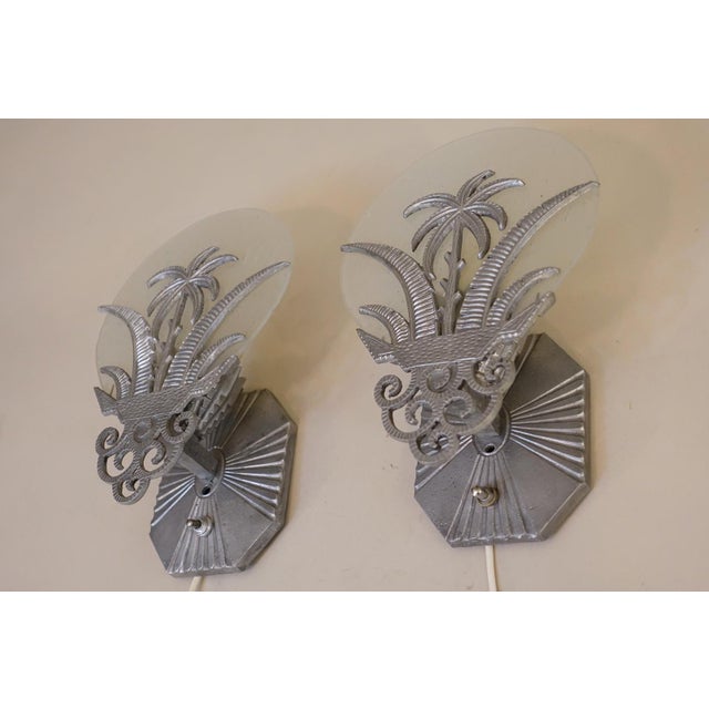These ultra dynamic rare French Art Deco styled tropical palm wall sconce lamps complete with bubbled glass disk shades...