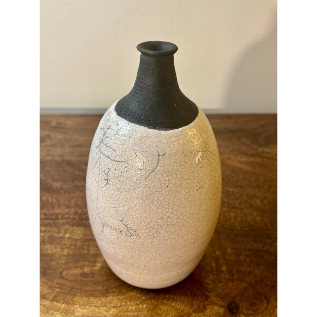 A beautifully formed American mid-century modern studio ceramic vase featuring a classic bud vase silhouette with a full-...