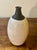 A beautifully formed American mid-century modern studio ceramic vase featuring a classic bud vase silhouette with a full-...