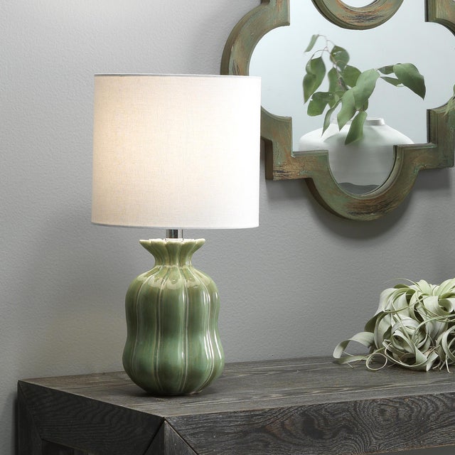 Complement any space with this distinctive table lamp. Handmade of ceramic, the base features vertical flutting...