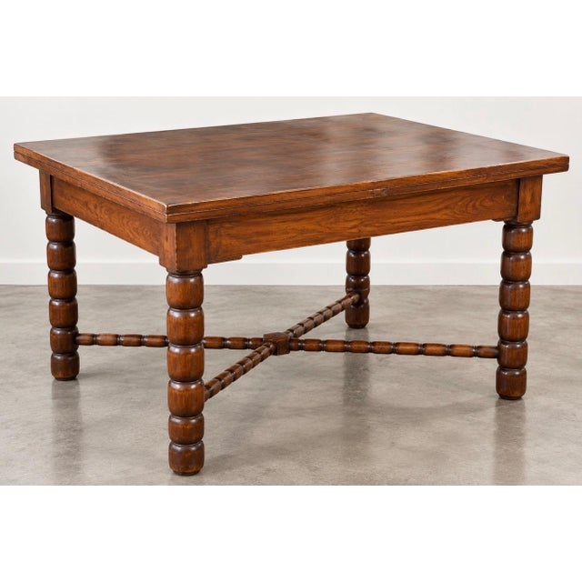 Extendable dining table (two 55 cm leaves) by Charles Dudouyt, solid wood, circa 1940, with spool legs. Very good...