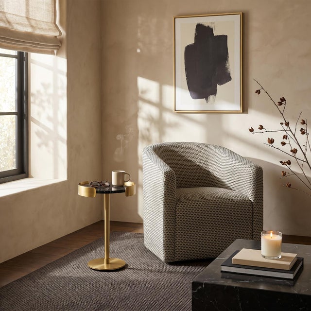 The Pedro Side Table pairs a black marble tray, marked by contrasting veining and a satin finish, with a natural brass...