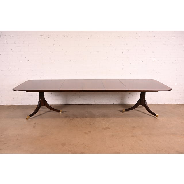 An exceptional Georgian or Regency style double pedestal extension dining table By Baker Furniture, "Stately Homes...