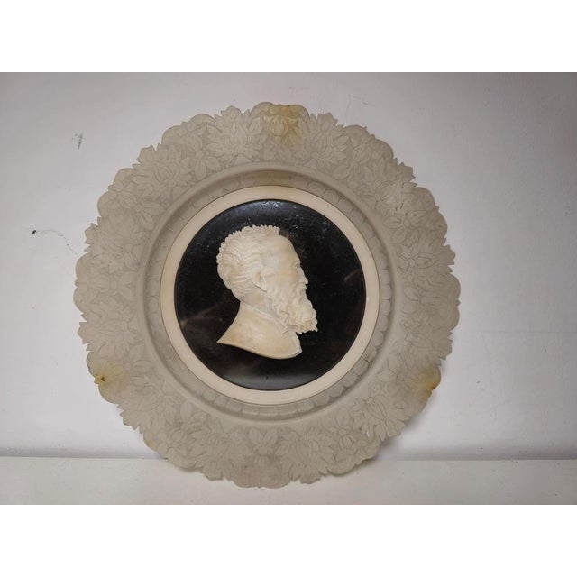 Presenting an exquisite antique Grand Tour dish carved in alabaster, featuring a detailed portrait relief of Michelangelo...