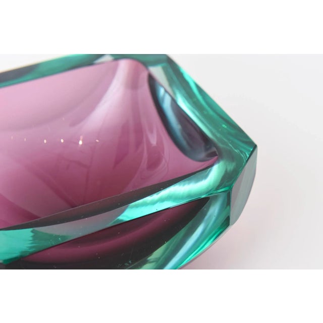 This stunning and richly colored Italian vintage murano bowl has the dual colors of the jewel tones of emerald green and...
