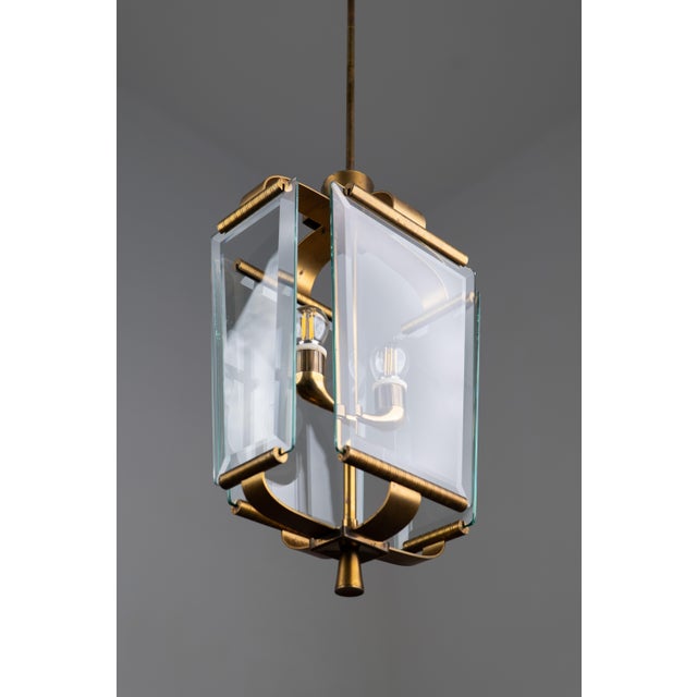 A rare brass chandelier was made in italy in the 1950s. The light is made in the shape of a lantern, completely made of...