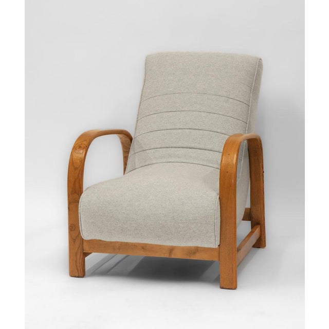 A stylish Art Deco elm bentwood and beechwood framed lounge chair with Bute light grey wool upholstery. Circa 1930s. The...