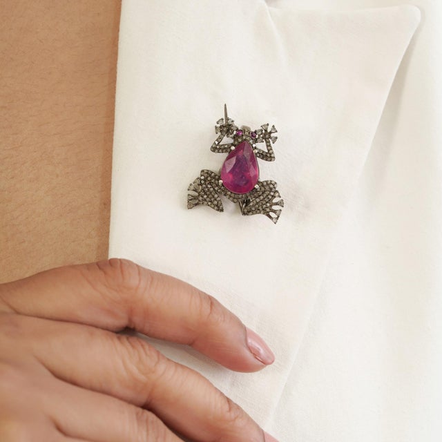The Antiqued Silver & 3 Ct Ruby Teardrop Diamond Pavé Frog Brooch Pendant draws attention with its distinctive figural...