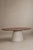 A table with a sculptural presence, where the warmth of solid wood meets the material simplicity of microcement. The oval...