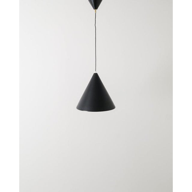 A rare swedish mid century cone ceiling pendant in matte black lacquered aluminum with brass details by hans-agne...