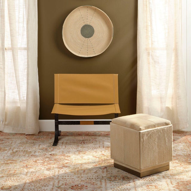 An unexpectedly elegant adaptation of a simple square hide-on-hair ottoman, this footstool’s slightly more formal lines...