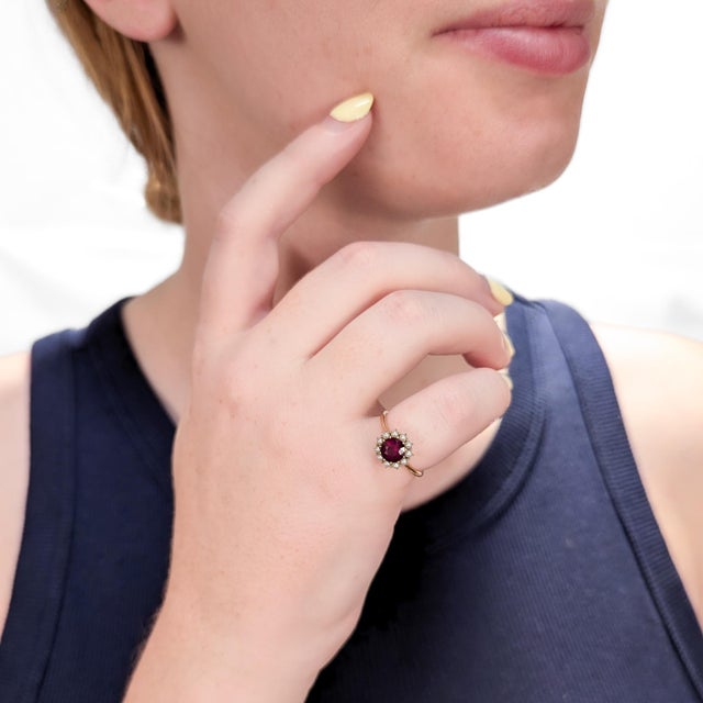 A fine signed American Mid-Century gold, garnet, and seed pearl cluster cocktail ring. In 14 karat yellow gold. By Jones &...