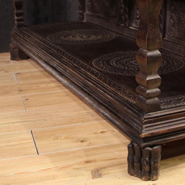 Italian sideboard from the mid-20th century. Rustic Valvaraita style cabinet finely carved in walnut and fruitwood, in a...