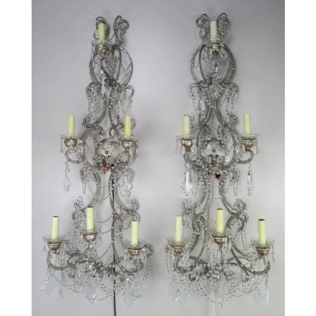 Pair of six-light Italian crystal beaded sconces in a silvered finish. Tiny beads decorate the frame of these sconces....