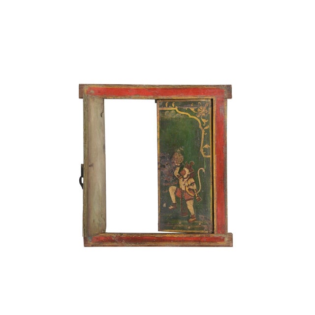This Antique Indian Painted Window is handcrafted from teakwood and adorned with vibrant hand-painted traditional Indian...