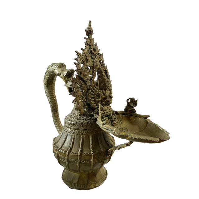 This exquisite 19th century Nepalese bronze ritual vessel boasts a realistic depiction of the one thousand hand Kuan yin...