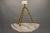 An impressive French Art Deco alabaster pendant light from the 1920s – sculptural in form, richly veined, and glowing with...