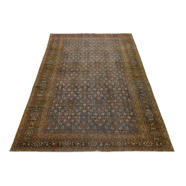 Discover the exquisite charm of this antique Persian Heriz wool rug. Its captivating rust-colored all-over design and...