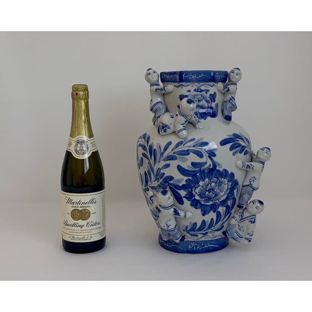 Vintage Chinese blue-and-white porcelain Fertility Boys vase featuring sculptural applied figures of boys climbing around...
