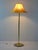 This vintage floor lamp features a round gold metal stem and base, lending a touch of luxury and sophistication to the...