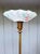 1940s torchiere lamp with a reverse painted, ruffled lampshade and a brass stem and brass and white onyx ornate base. It's...