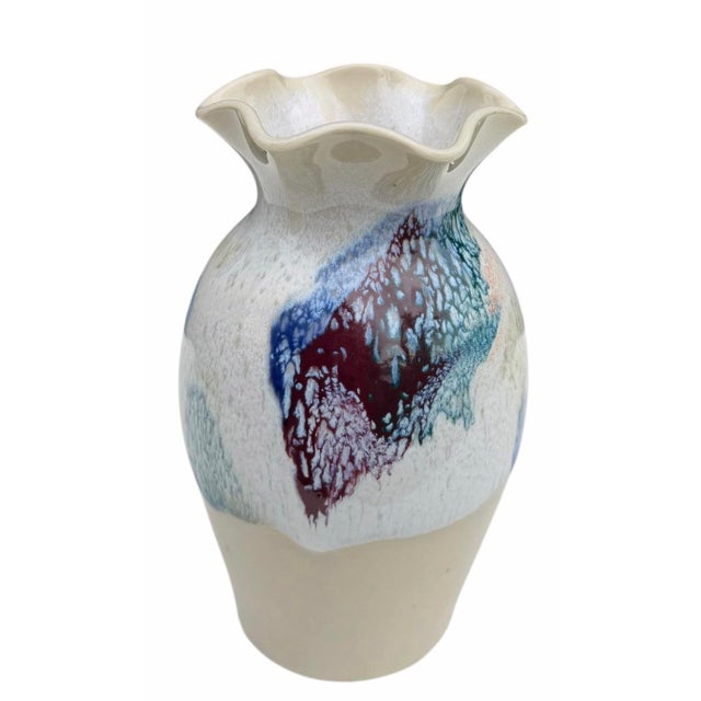 Vintage studio pottery art vase featuring a sculptural form with a ruffled rim and flowing drip glaze in shades of...