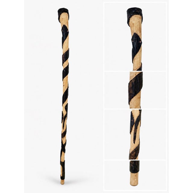 A striking vintage hand-carved wooden walking cane featuring a beautifully carved serpent head with painted red eyes and a...