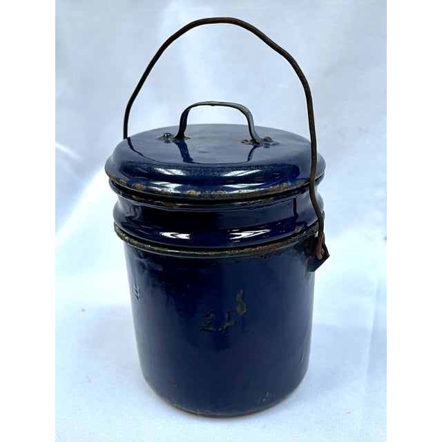 Classic dark blue french enamel lunch pail with removable tray. Wire handle. Original import sticker. The pail measures...