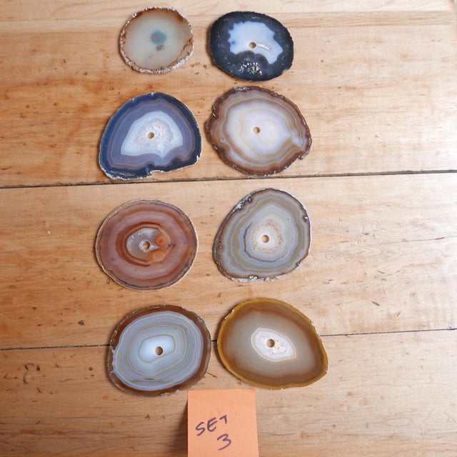 A set of natural stone circular drink place mats or coasters. Likely Agates. France, c1970s. A variety of colours and...