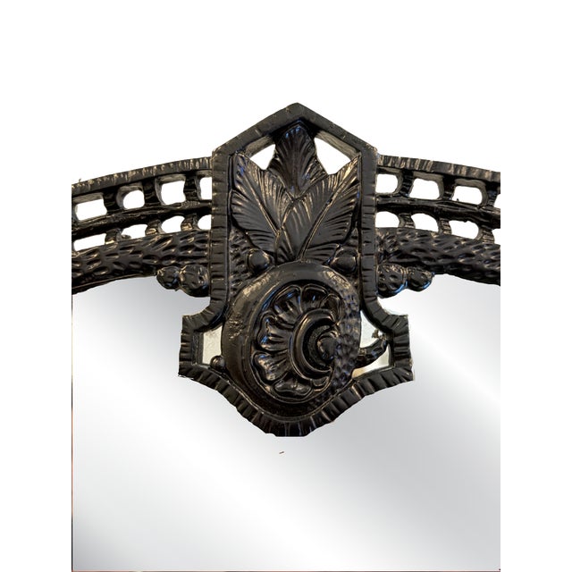 Original French 1920s mirror with Art Noveau network featuring central floral motif, hammered metal detail, curly ends and...