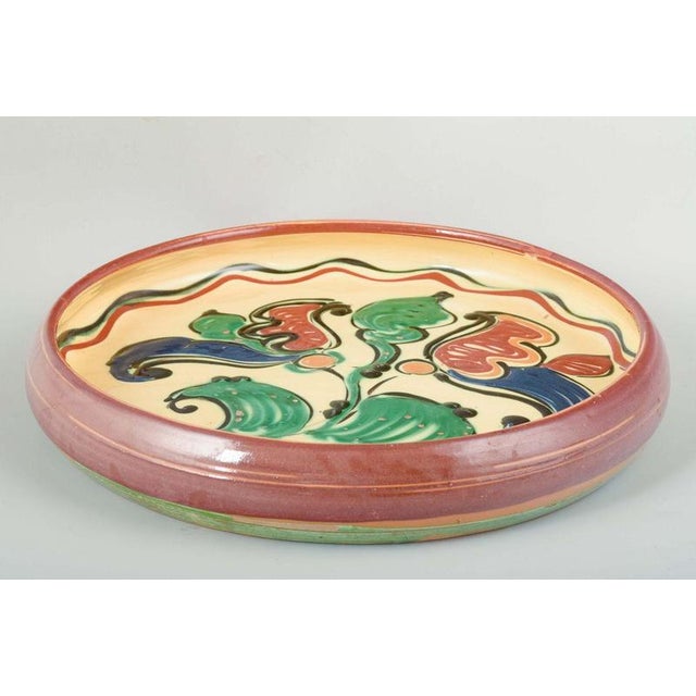 Kähler, Denmark Decorative wall or serving dish in glazed ceramic with a polychrome floral motif in vibrant colors on a...