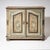 A two-door half cabinet in softwood featuring its original painted finish in pastel green and ochre tones. The front is...