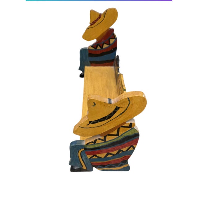Vintage colorful handpainted wooden Mexican folk art style shelf featuring sombrero wearing figures on the...