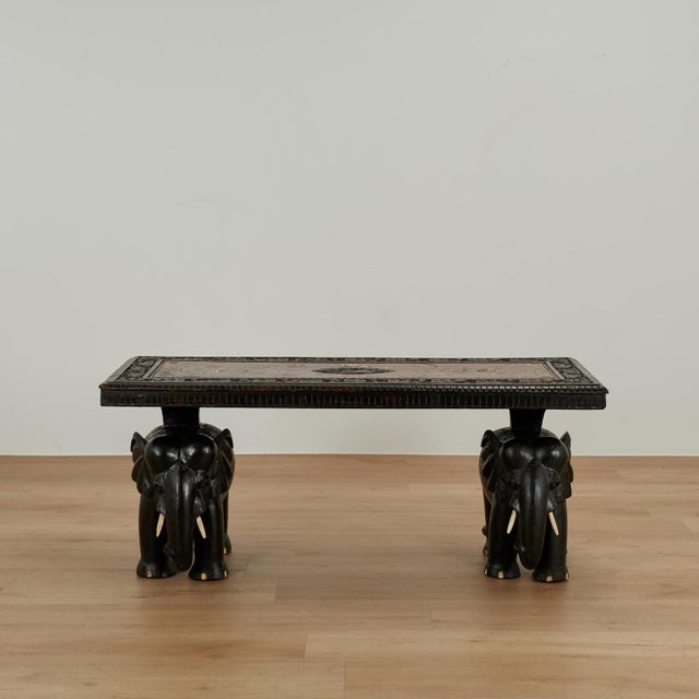 Impressive antique Anglo Indian table crafted in teak having a top with a center carved elephant and bone inlaid elephants...