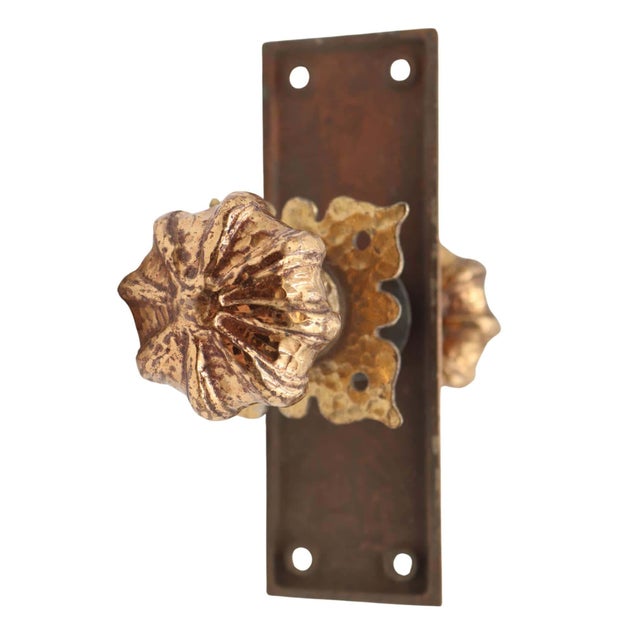 Vintage brass passage door knob set made of gilt textured door knobs, a plain rectangular back plate, and a textured...