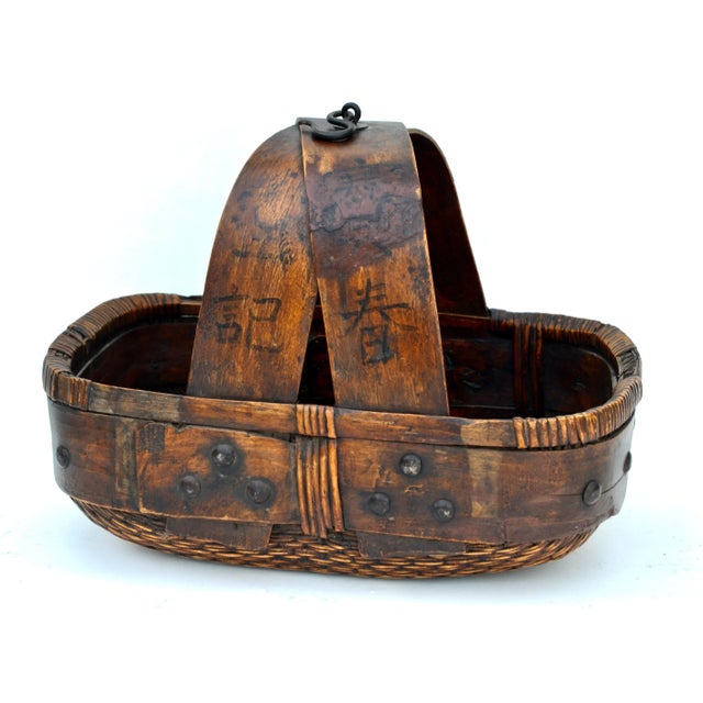 A fine early 20th Century Chinese basket traditionally used to carry grain made with willow and bamboo with iron bolts and...
