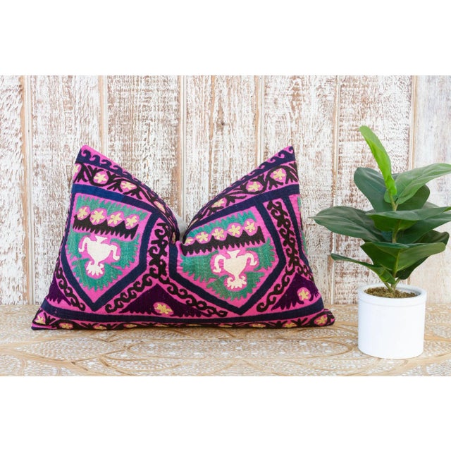 Made from a vintage Suzani tapestry, it features hand done embroidery and a solid linen back. Suzani is a Persian word...