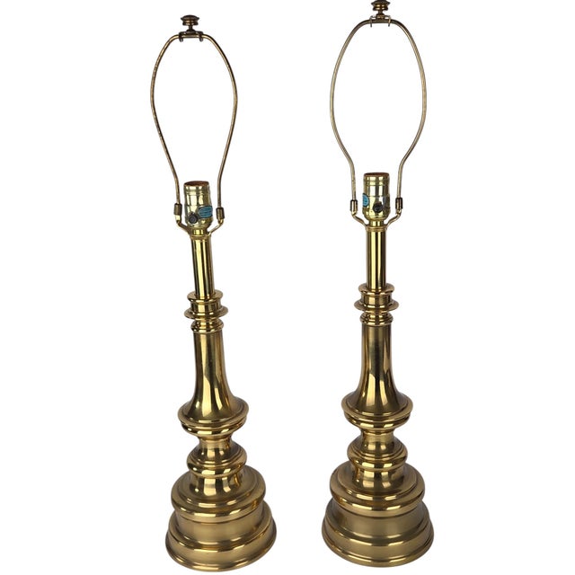 A pair of vintage table lamps by Stiffel, Chicago, in polished brass with a tiered baluster stem over a stepped, graduated...
