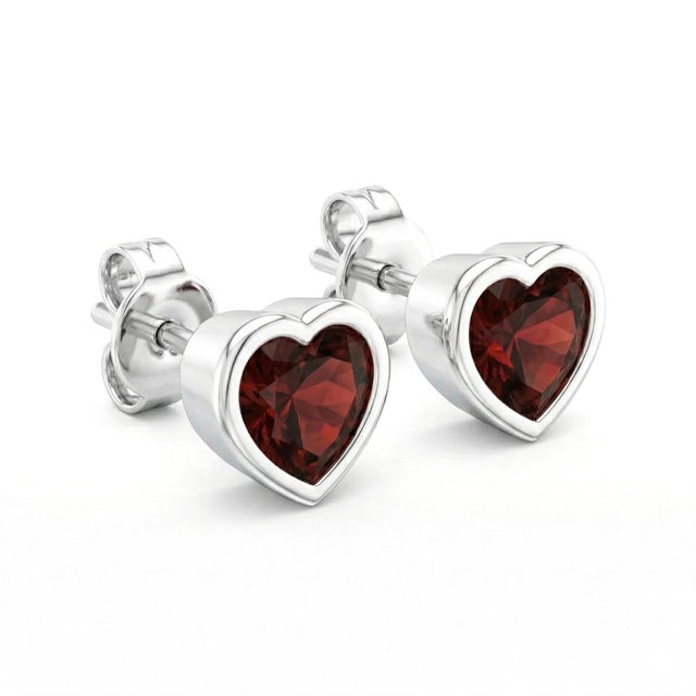 These elegant stud earrings feature vibrant Garnet gemstones, admired for their deep red hue and captivating brilliance....