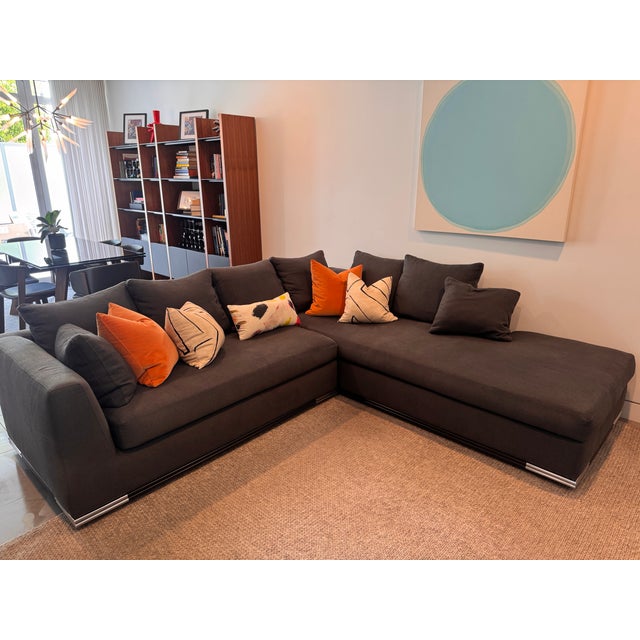 The Architecte sectional by Nathan Anthony. With its stunning double-stacked wood base with shiny metal corners acts like...