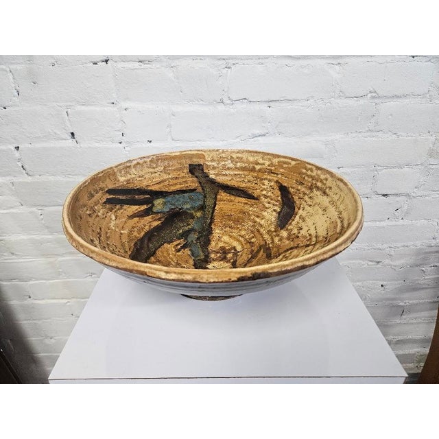 Vintage mid-century modern studio pottery charger bowl. Perfect as a centerpiece bowl or wall-mounted art piece, it...