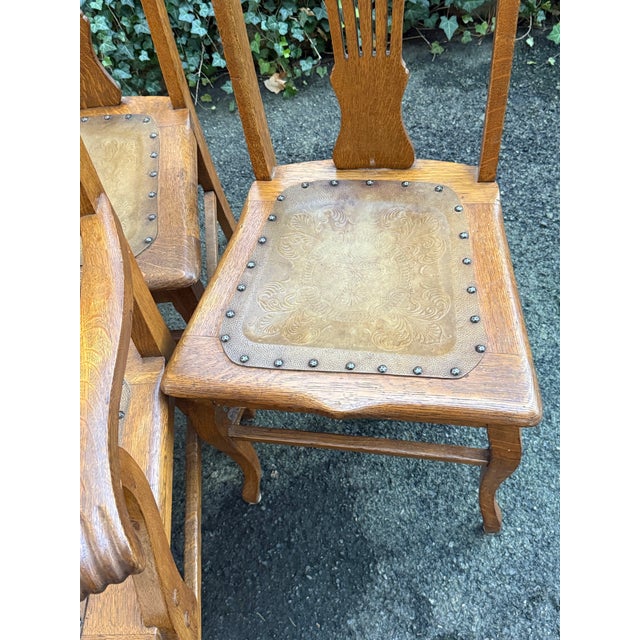 Beautiful set of four antique oak dining chairs, featuring striking quarter-sawn tiger oak grain and richly detailed...