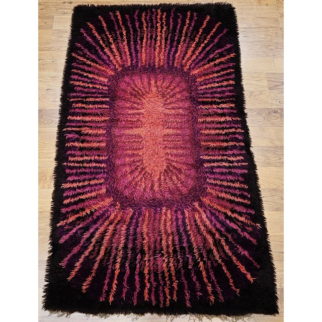 36” x 63” Wonderful and colorful mid century modern Rya area rug in crimson, red, pink, and brown colors. Dimensions: 36”...